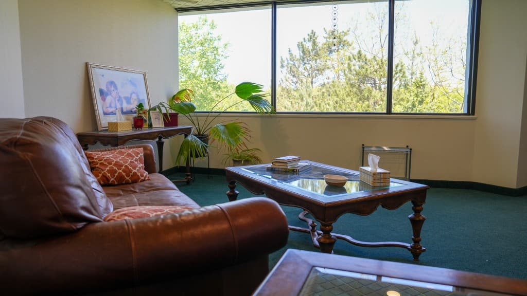 Comfortable therapy suite with seating and natural light